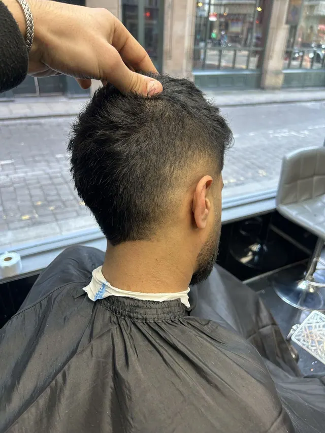 A messy crop with a taper, by the window